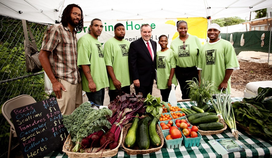 Mayor Daley with employees of Growing Home at a market stand.